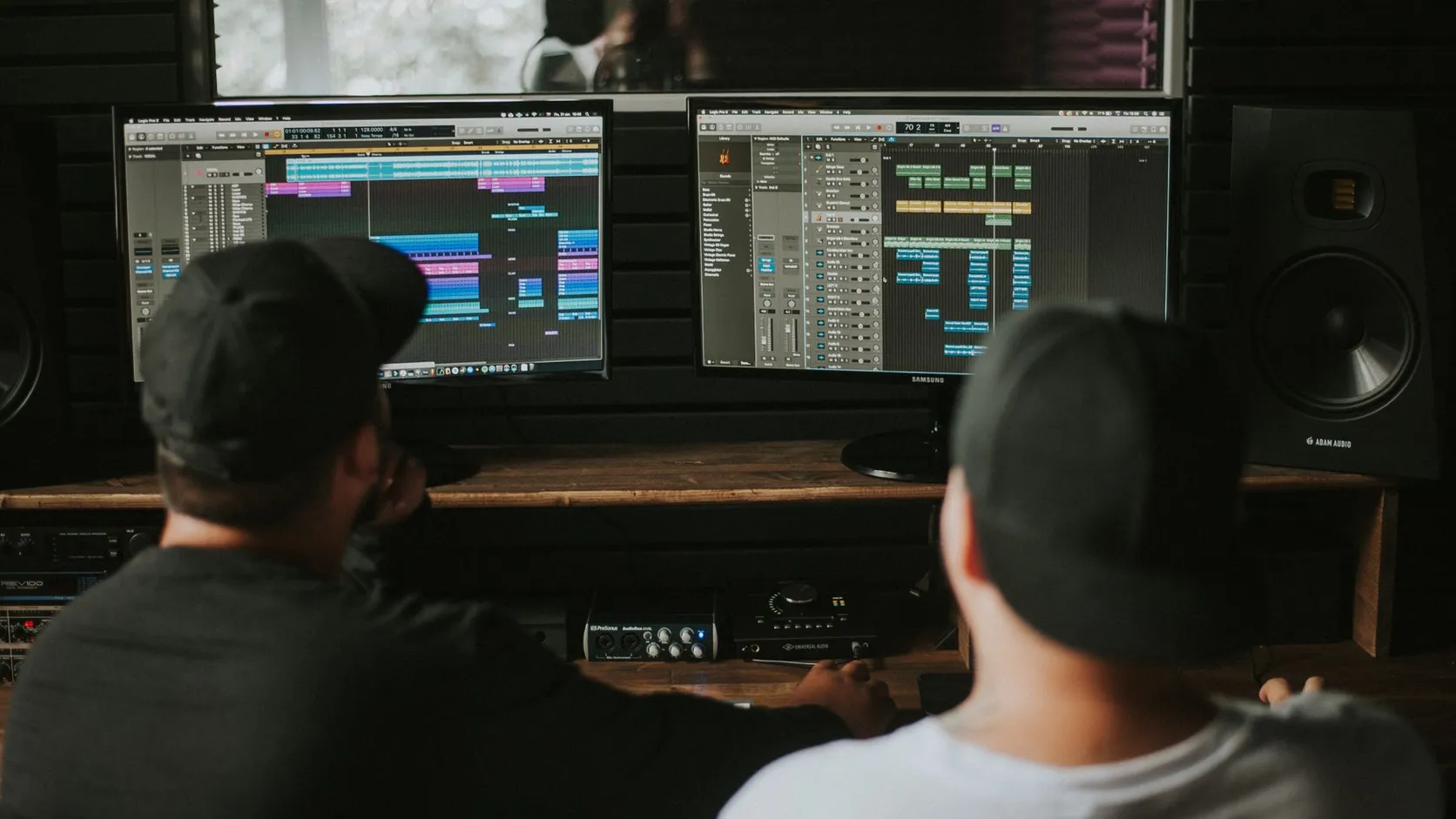 Producer working at a mixing desk in a dark studio